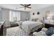 Serene bedroom with a king-size bed, plush seating, and a ceiling fan at 5310 Esparon Ave, Las Vegas, NV 89141