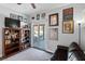 Cozy Gathering room featuring built-in shelving, a TV, and sliding glass doors leading to the backyard at 5310 Esparon Ave, Las Vegas, NV 89141