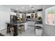 Updated kitchen with white cabinets, a large island and stainless steel appliances at 5310 Esparon Ave, Las Vegas, NV 89141