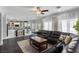 Open living room with kitchen view, sectional sofa, and hardwood floors at 5310 Esparon Ave, Las Vegas, NV 89141