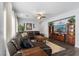 Comfortable living room featuring sectional sofa, media center, and hardwood floors at 5310 Esparon Ave, Las Vegas, NV 89141