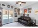 Charming office with a leather couch, and sliding glass doors leading to the pool at 5310 Esparon Ave, Las Vegas, NV 89141