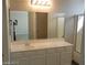 Bathroom featuring a large vanity with framed mirror and separate shower at 6225 Dan Blocker Ave # 102, Henderson, NV 89011