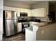 Kitchen features stainless steel appliances, white cabinets, and granite countertop at 6225 Dan Blocker Ave # 102, Henderson, NV 89011