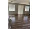Living room with large windows and hardwood floors at 6225 Dan Blocker Ave # 102, Henderson, NV 89011