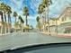 Gated community street lined with palm trees and well-maintained landscaping at 6225 Dan Blocker Ave # 102, Henderson, NV 89011