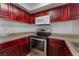 Kitchen with dark wood cabinets and granite countertops at 6800 E Lake Mead Blvd # 2035, Las Vegas, NV 89156