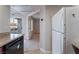 Kitchen features a white refrigerator and dark wood cabinets at 6800 E Lake Mead Blvd # 2035, Las Vegas, NV 89156