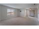 Bright living room with patio access and carpet at 6800 E Lake Mead Blvd # 2035, Las Vegas, NV 89156