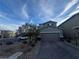 Attractive two-story home with a two-car garage, desert landscaping, and a spacious driveway at 8719 Rio Andir Ave, Las Vegas, NV 89148