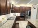 Modern kitchen with dark wood cabinets and granite countertops at 8719 Rio Andir Ave, Las Vegas, NV 89148