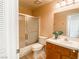 Clean bathroom with shower/tub combo, toilet and wood vanity at 9552 Wooden Pier Way, Las Vegas, NV 89117