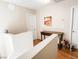 Upstairs hallway with wood floors, built-in console table, and doors to bedrooms at 9552 Wooden Pier Way, Las Vegas, NV 89117