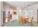 Bright dining area with wood table and chairs, adjacent to kitchen at 1324 Spice Ridge Ct, Henderson, NV 89012