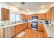 Modern kitchen with wood cabinets, stainless steel appliances, and granite counters at 1324 Spice Ridge Ct, Henderson, NV 89012