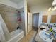Bathroom with double sinks, granite countertops, and tiled tub/shower at 1771 Labrador St, Pahrump, NV 89048