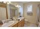 Bathroom with double sinks, granite countertops, and tiled shower at 1771 Labrador St, Pahrump, NV 89048