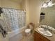 Well-lit bathroom features a shower-tub combo and vanity with granite counters at 1771 Labrador St, Pahrump, NV 89048