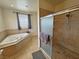 Relaxing soaking tub and separate shower in the main bathroom at 1771 Labrador St, Pahrump, NV 89048