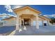 Inviting home exterior showcasing a covered drive, well-maintained stucco, and a two-car garage at 1771 Labrador St, Pahrump, NV 89048