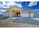 Charming home exterior featuring a covered drive, complemented by a well-manicured front yard at 1771 Labrador St, Pahrump, NV 89048