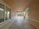 Hallway showcasing an open floor plan, bright windows, and stucco walls leading to the front yard at 1771 Labrador St, Pahrump, NV 89048
