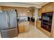 Well-equipped kitchen featuring built-in oven and stainless steel refrigerator at 1771 Labrador St, Pahrump, NV 89048