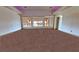 Spacious living room with carpet flooring, natural light, and a view of the outdoor patio at 1771 Labrador St, Pahrump, NV 89048