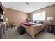 Bedroom with brown walls and carpet features bed with warm blankets and soft lighting at 204 Cimarron Ct, Henderson, NV 89002