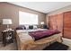 Bedroom with neutral walls and carpet, featuring a queen bed and wardrobe closet at 204 Cimarron Ct, Henderson, NV 89002