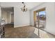 This is a spacious dining room area with tile flooring and sliding glass doors to the outdoor space at 204 Cimarron Ct, Henderson, NV 89002