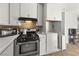 Cozy kitchen with white cabinetry, and essential appliances for convenient meal preparation at 204 Cimarron Ct, Henderson, NV 89002
