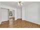Bedroom featuring wood-look floors, ceiling fan, and sliding door mirrored closet at 2050 W Warm Springs Rd # 3322, Henderson, NV 89014