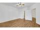Spacious bedroom with wood-look floors, ceiling fan, and access to two bathrooms at 2050 W Warm Springs Rd # 3322, Henderson, NV 89014