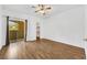 Bright bedroom with wood-look floors, ceiling fan, closet, and sliding glass doors to a private balcony at 2050 W Warm Springs Rd # 3322, Henderson, NV 89014