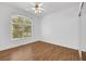 Bright bedroom with wood-look flooring, large window, and a ceiling fan at 2050 W Warm Springs Rd # 3322, Henderson, NV 89014