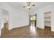 Open bedroom with wood-look floors, closet, and sliding glass doors to a private balcony at 2050 W Warm Springs Rd # 3322, Henderson, NV 89014