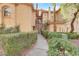 Inviting stucco townhouse with a well-maintained, hedge-lined walkway to the front door at 2050 W Warm Springs Rd # 3322, Henderson, NV 89014