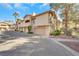 A townhouse exterior featuring private garages, balconies, and neatly trimmed landscaping at 2050 W Warm Springs Rd # 3322, Henderson, NV 89014