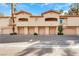 A row of townhouses with garages, balconies, and well-kept landscaping in front at 2050 W Warm Springs Rd # 3322, Henderson, NV 89014
