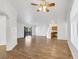 Spacious living room featuring hardwood floors, a ceiling fan, and sliding glass door to a private balcony at 2050 W Warm Springs Rd # 3322, Henderson, NV 89014