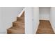 Wood-look staircase with white walls leading to another room at 2050 W Warm Springs Rd # 3322, Henderson, NV 89014