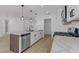 Modern kitchen featuring white cabinets, quartz countertops, and stainless steel appliances at 2220 Patriotic Ln, North Las Vegas, NV 89032