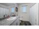 Well-lit bathroom with a vanity, granite countertop, and shower-tub combination at 2681 Tuxedo Black Ct, North Las Vegas, NV 89086