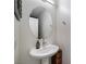 Stylish powder room with a pedestal sink, oval mirror, and neutral decor at 2681 Tuxedo Black Ct, North Las Vegas, NV 89086