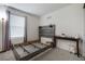 An empty bedroom is bright and airy, featuring a weathered headboard and modern decor accents at 2681 Tuxedo Black Ct, North Las Vegas, NV 89086