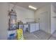 Functional laundry room with washer, dryer, sink, and water heater at 2741 Meadow Park Ave, Henderson, NV 89052