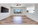 Bright living room with hardwood flooring and large window features a modern entertainment area at 2741 Meadow Park Ave, Henderson, NV 89052