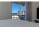 A simple bedroom has balcony access with a gorgeous view of the Sahara hotel and casino in the distance at 2777 Paradise Rd # 1105, Las Vegas, NV 89109