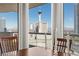 Inviting dining room showcases city views through large windows and a wooden dining set at 2777 Paradise Rd # 1105, Las Vegas, NV 89109